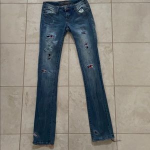 Light wash jeans with red, white, blue patches